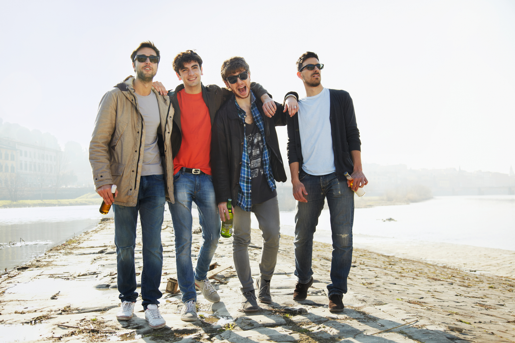 Group of friends walking along the river