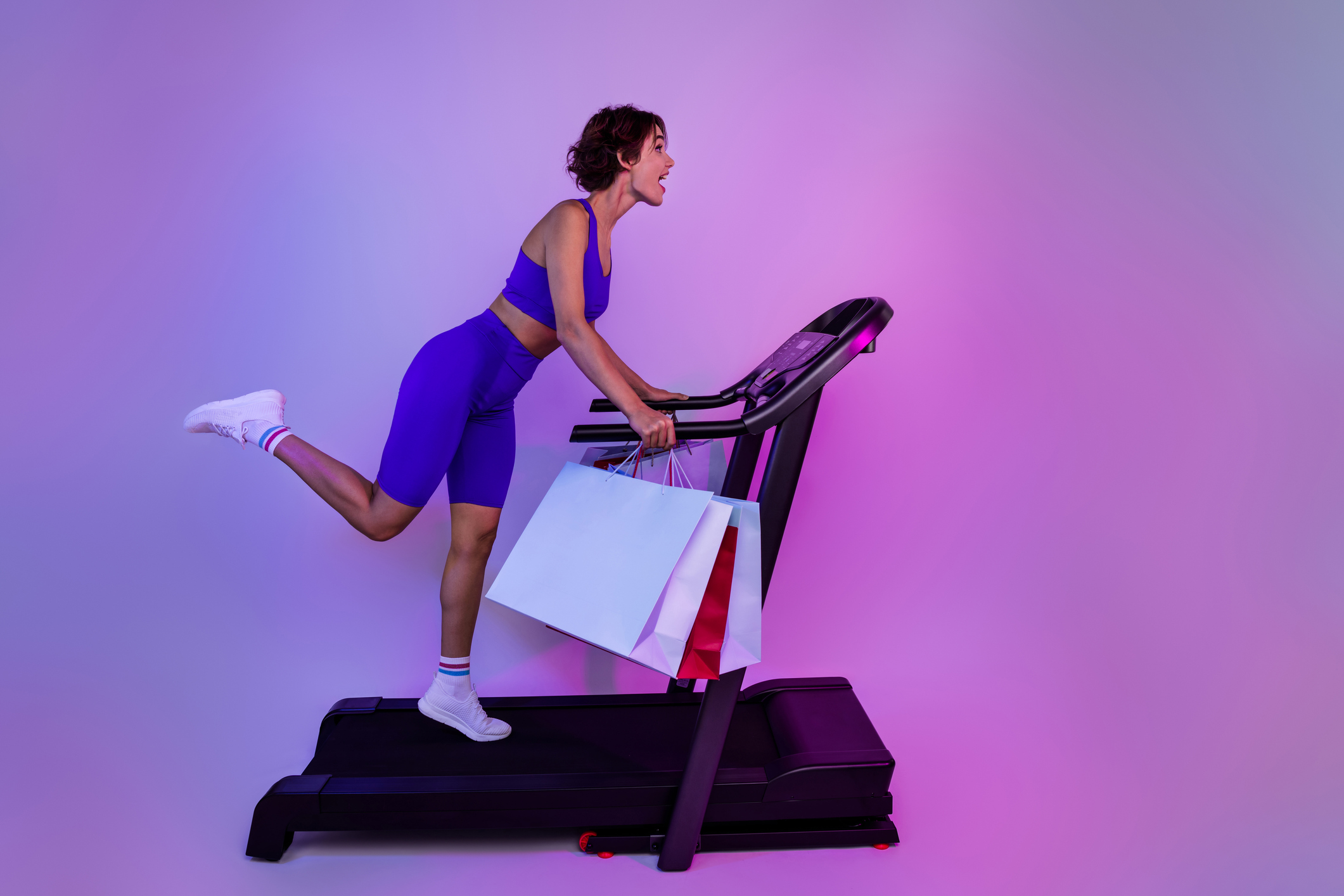Photo of sporty girl shopaholic run fast on treadmill for black friday sales isolated on ultraviolet color background
