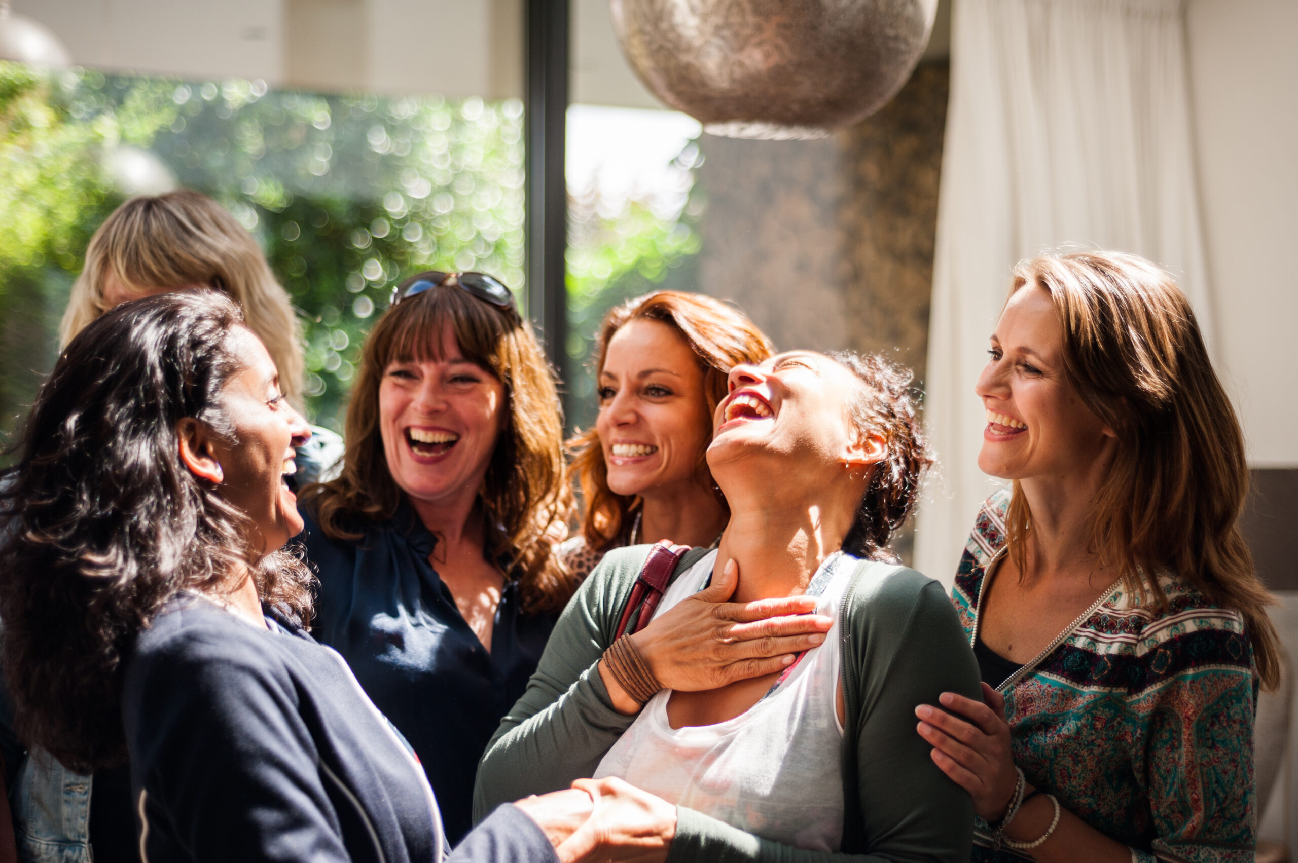 Women at reunion greeting and smiling